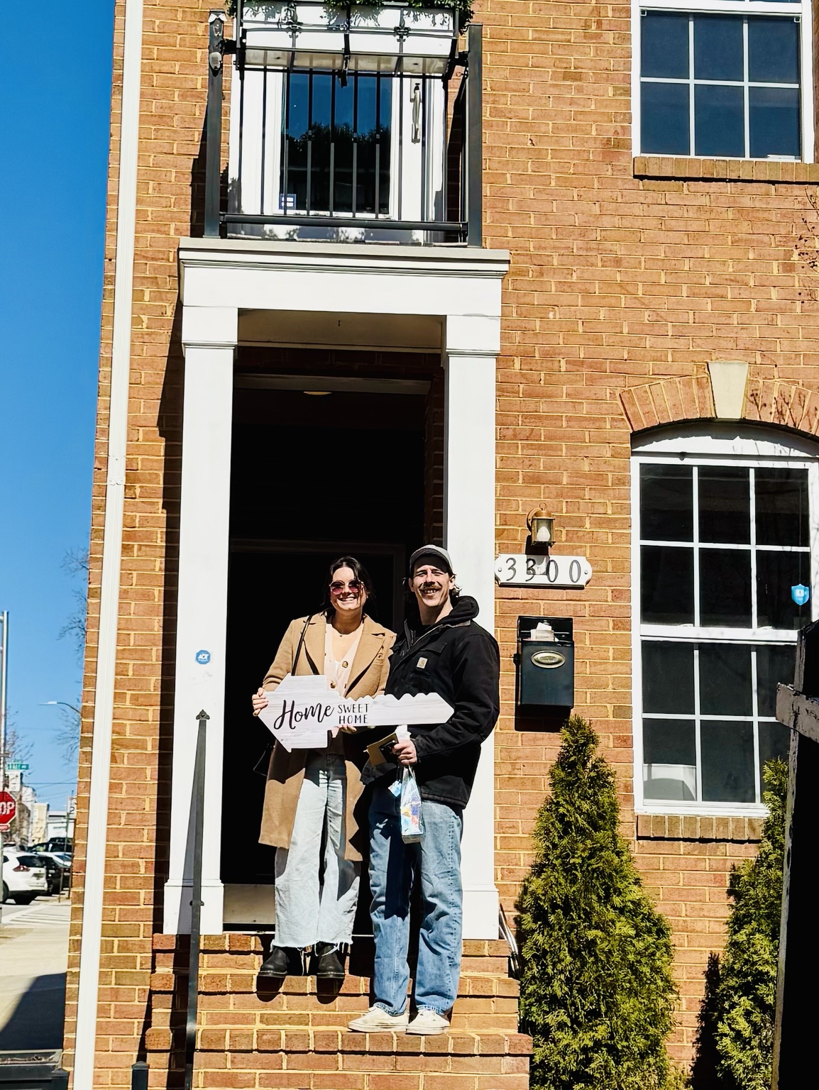 Canton buyers celebrating in front of their new home